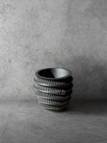 Vesseld.com 3D Printed Textured Design Black Cylindrical Planter on a gray concrete background
