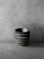 Vesseld.com 3D Printed Textured Design Black Cylindrical Planter on a gray concrete background