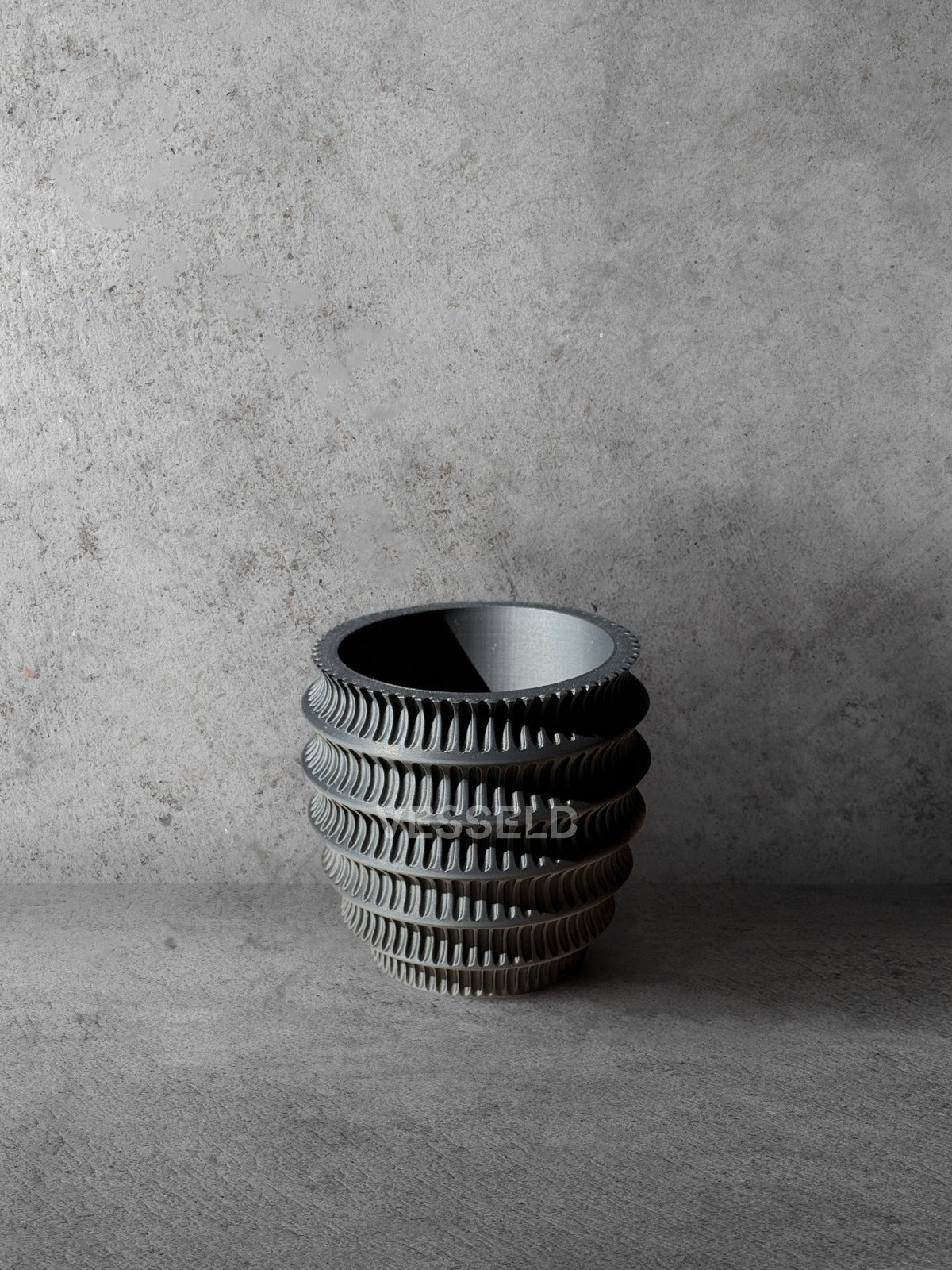 Vesseld.com 3D Printed Textured Design Black Cylindrical Planter on a gray concrete background