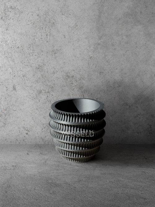 Vesseld.com 3D Printed Textured Design Black Cylindrical Planter on a gray concrete background