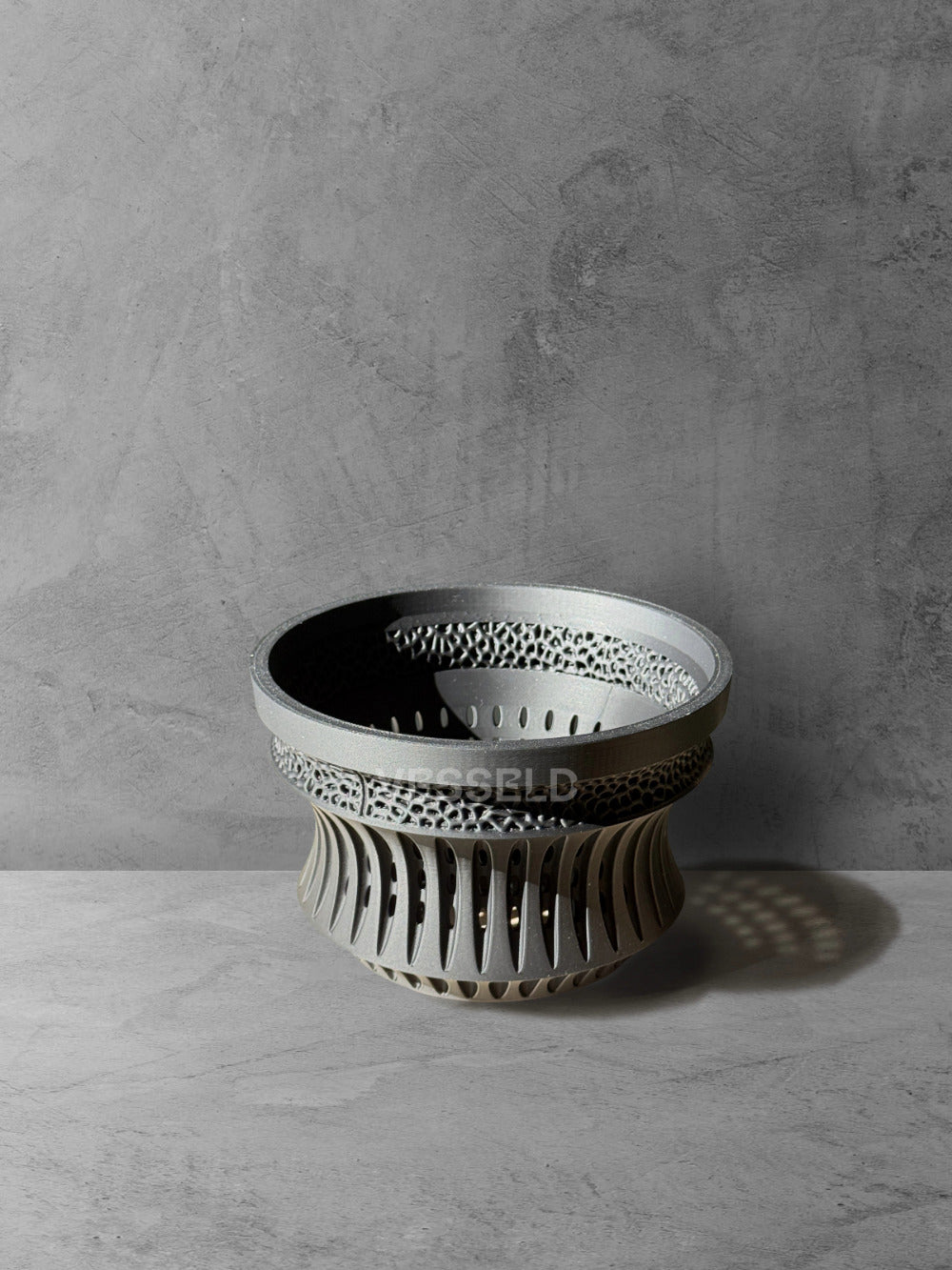 Vesseld.com 3D Printed Pot with textured design on a gray surface