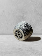 Vesseld.com Bottom of 3D Printed Textured Black Planter on a gray surface