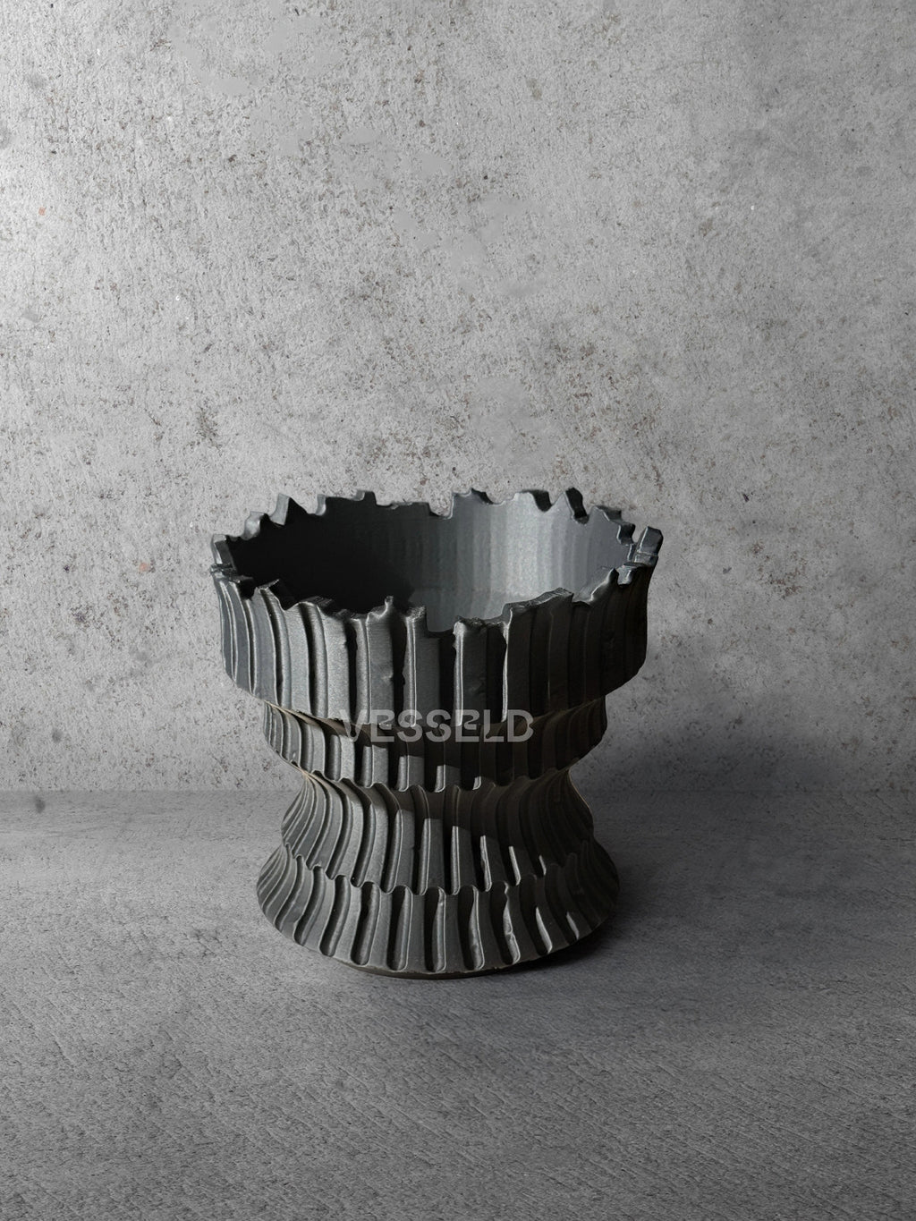 Vesseld.com 3D Printed Textured Black Cylindrical Planter on a concrete background