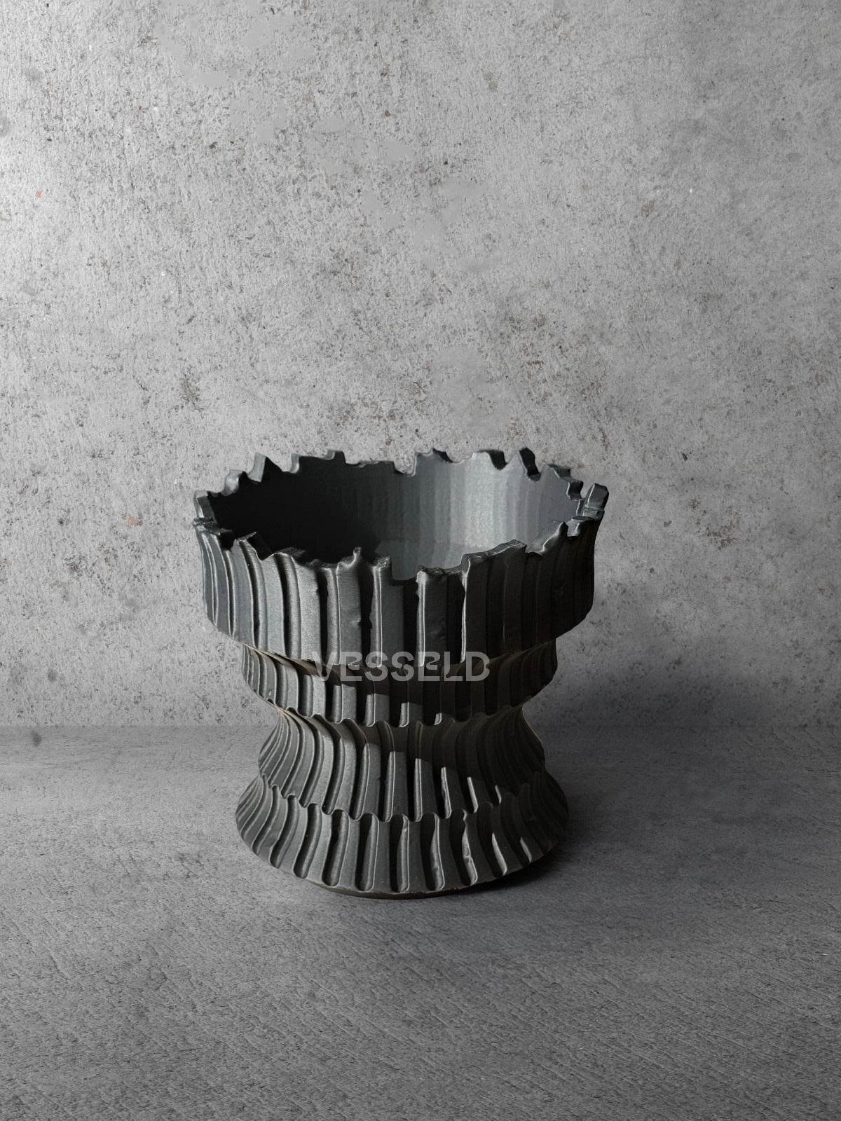 Vesseld.com 3D Printed Textured Black Cylindrical Planter on a concrete background
