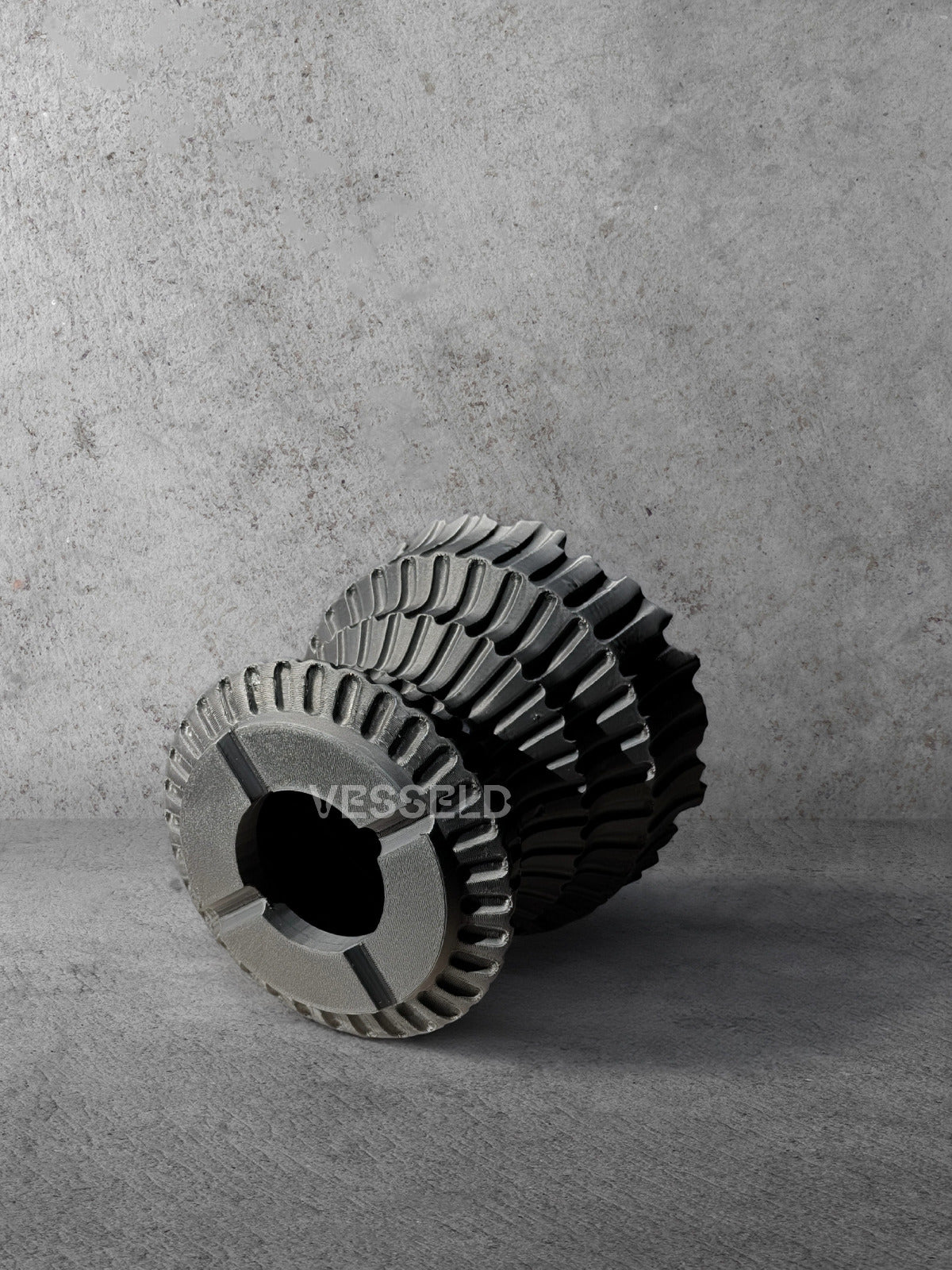 Vesseld.com Bottom of 3D Printed Textured Black Cylindrical Planter on a concrete background