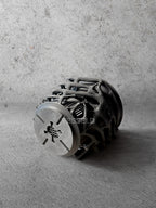 Vesseld.co Bottom of Black textured 3D Printed Cylindrical Planter on a concrete surface