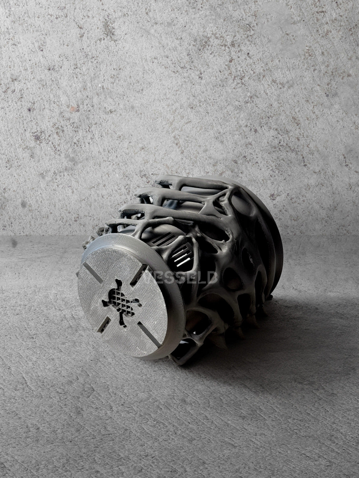 Vesseld.co Bottom of Black textured 3D Printed Cylindrical Planter on a concrete surface