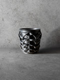Vesseld.com Black textured 3D Printed Cylindrical Planter on a concrete surface