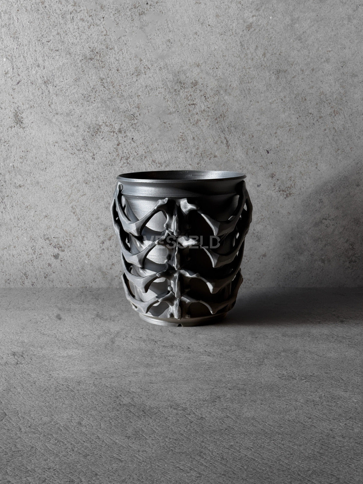 Vesseld.com Black textured 3D Printed Cylindrical Planter on a concrete surface